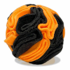 Glory To Dog snuffle ball shown from the front in orange and black.