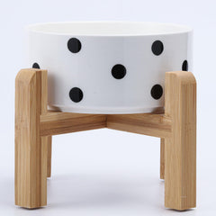 Petygooing ceramic pet bowl shown from the front with its bamboo stand.
