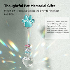 AMETHUARTZ pet memorial suncatcher hanging beside a sunlit window.