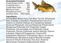 Aqueon Shrimp Pellets Fish Food shown being fed to bottom-feeding fish.