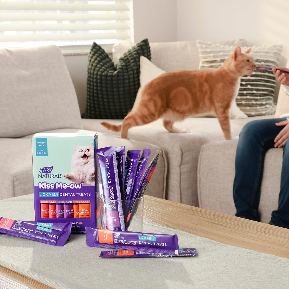 ARK NATURALS Kiss Me-Ow cat treats shown being offered directly to a cat.