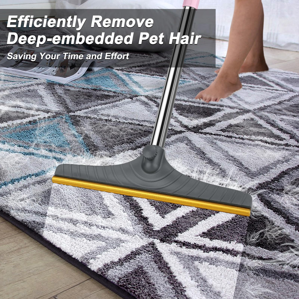 B-Land carpet rake shown with its adjustable long handle extended.