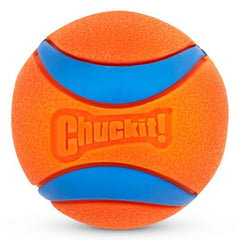 Chuckit! Ultra Rubber Dog Balls beside the bucket with its lid converted into a water bowl.