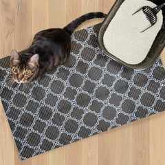 Fresh Kitty foam litter mat showing the black and white quatrefoil design.