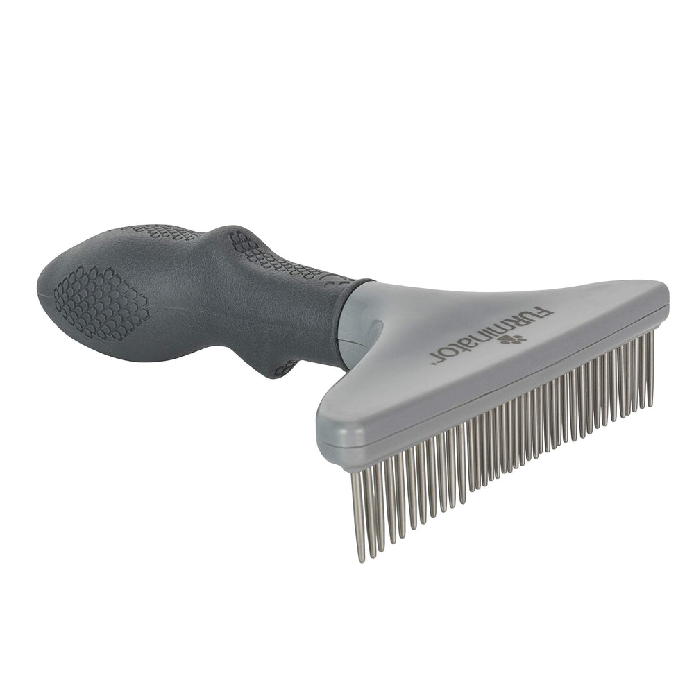FURminator Grooming Rake being used to brush a cat.