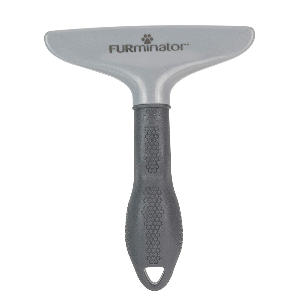 FURminator Grooming Rake being used to brush a dog.