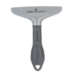 FURminator Grooming Rake being used to brush a dog.