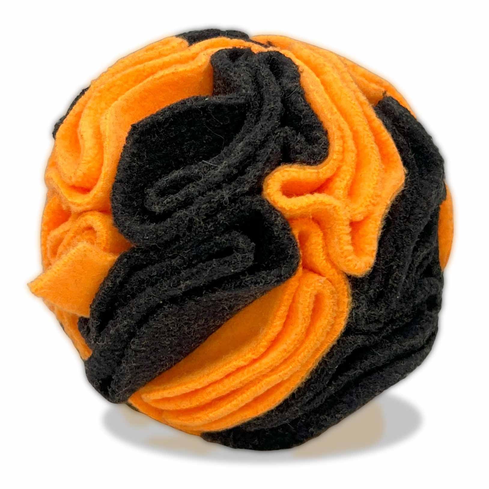 Glory To Dog snuffle ball shown from the front in orange and black.