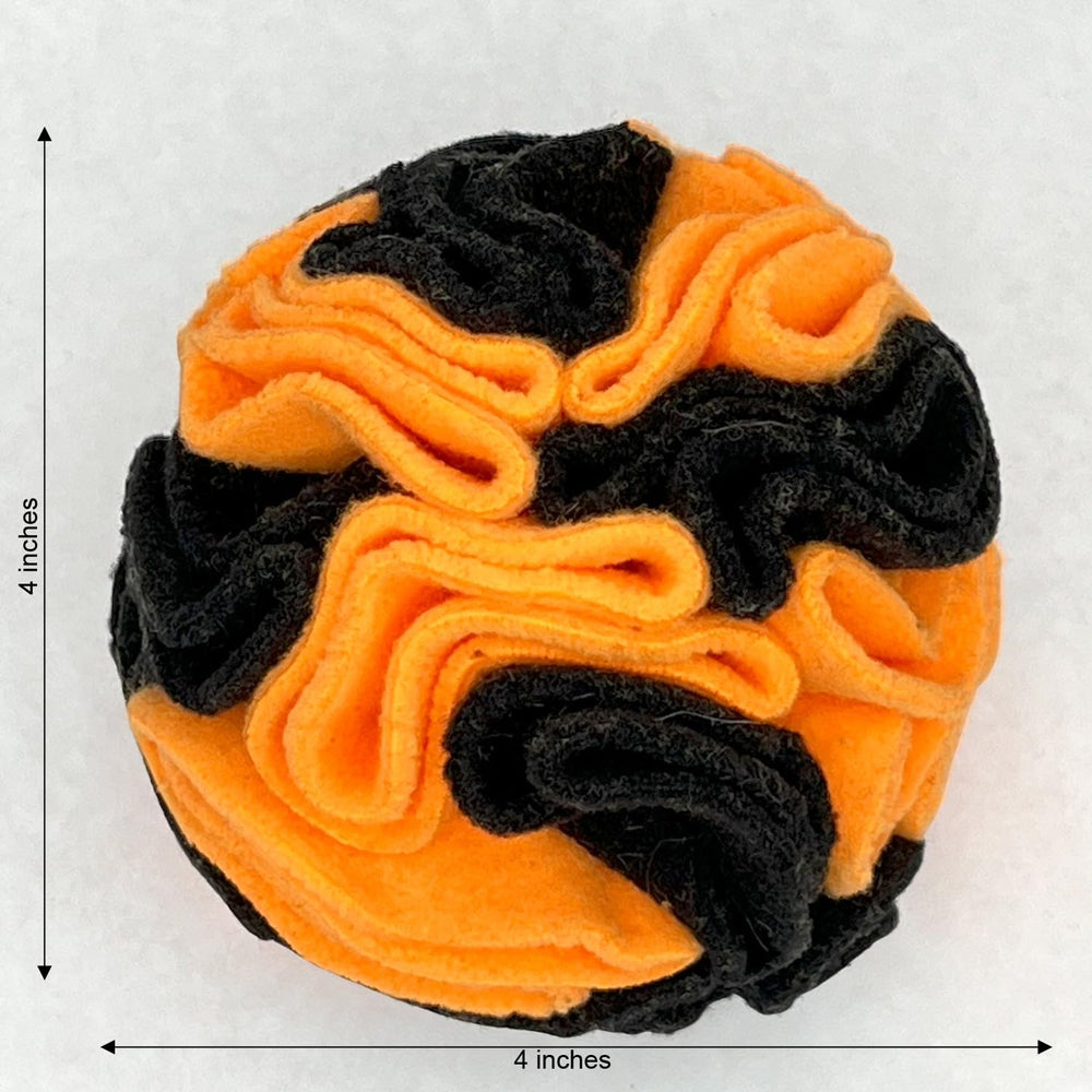 Glory To Dog snuffle ball shown from an alternate angle in orange and black.