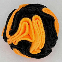Glory To Dog snuffle ball with a treat tucked into its folds for searching.