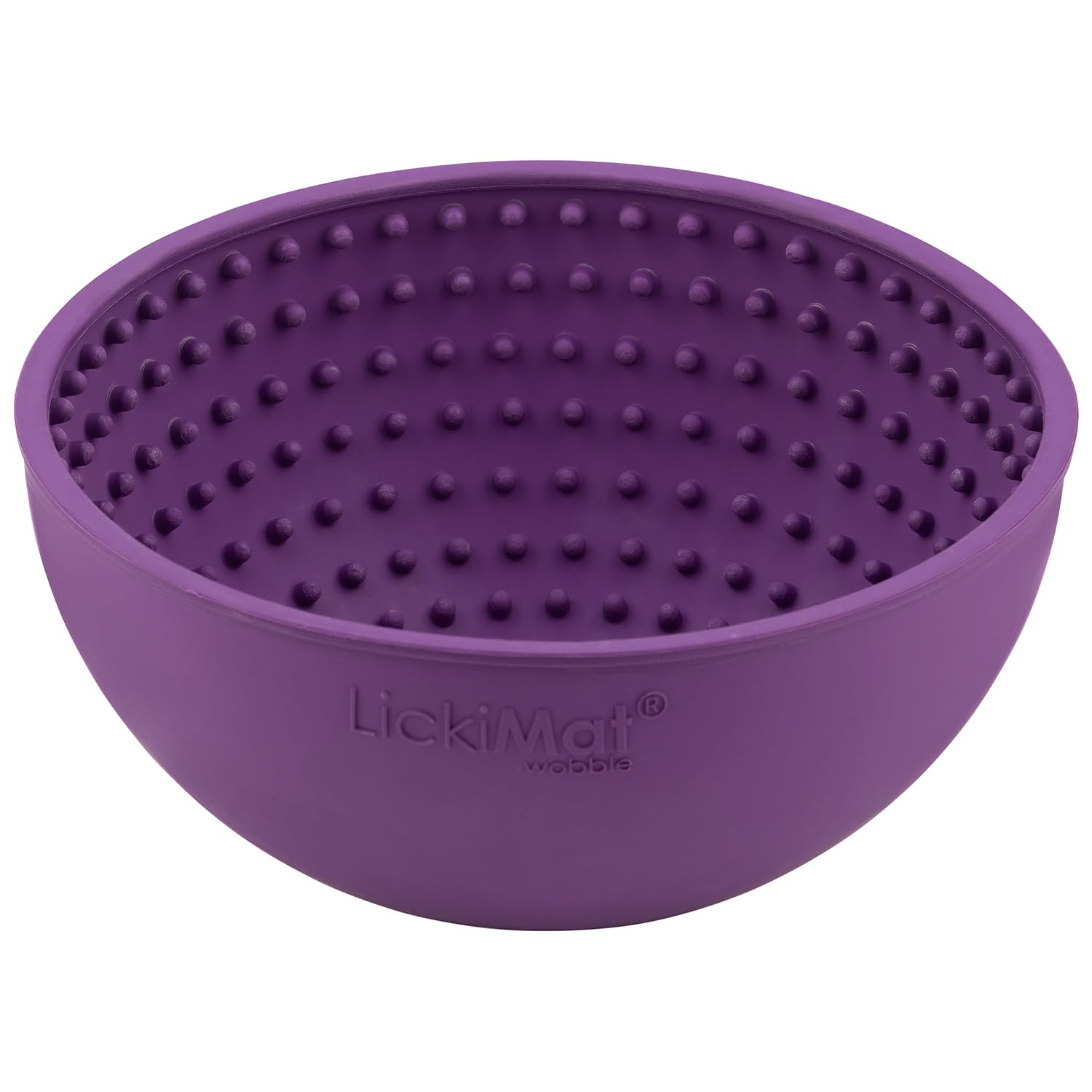 A dog licking food from the purple LICKIMAT Wobble dog lick mat.