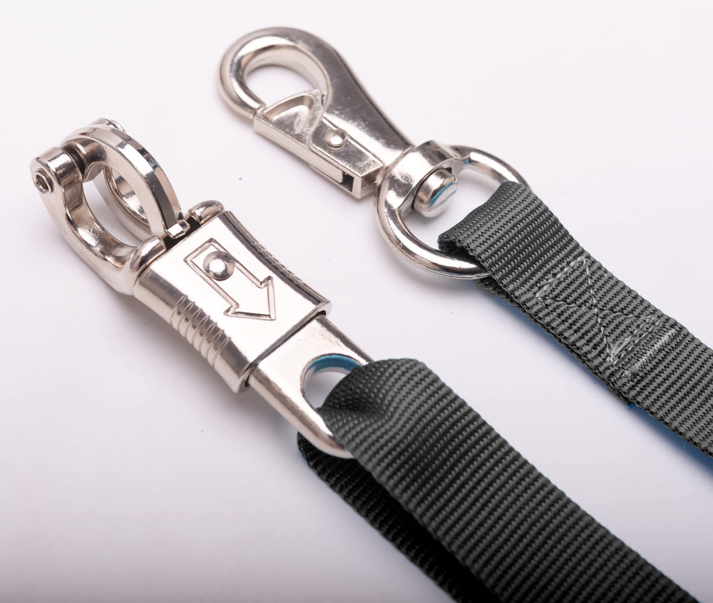 Loaged adjustable nylon cross ties shown in a horse cross-tie setup.