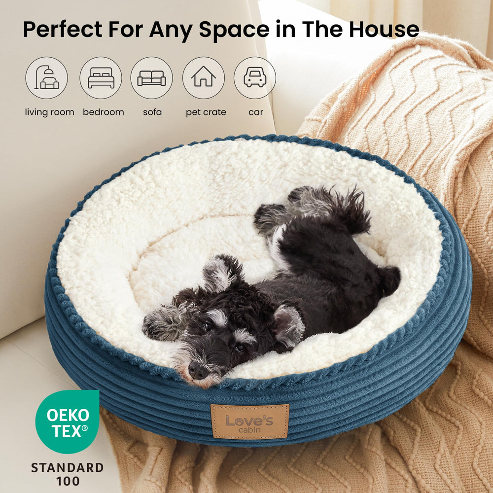 Love's cabin dusty blue round pet bed shown with a pet resting in it.