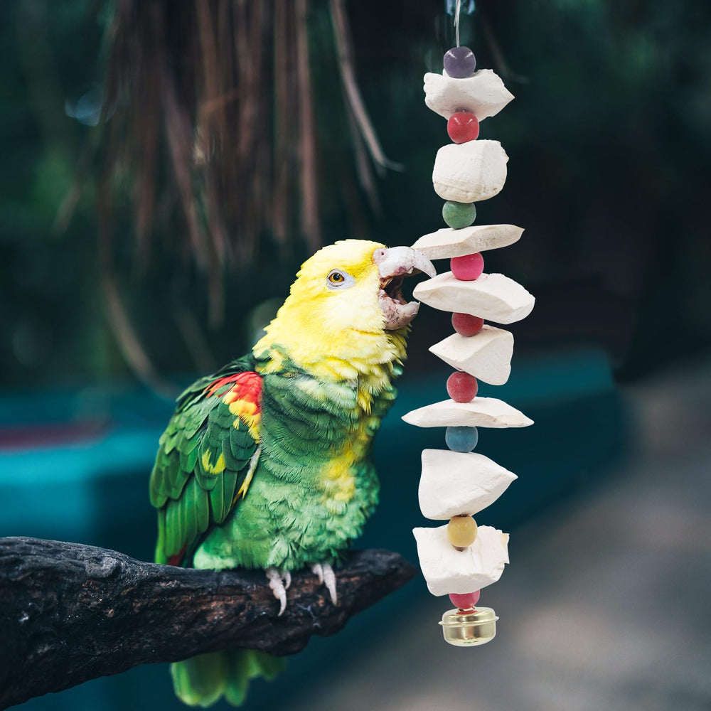 A bird interacting with an MHLLGN bird toy in its cage.