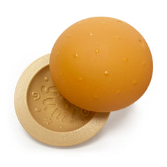 Nylabone Strong Chew Bun Treat Toy shown with kibble in its pockets.