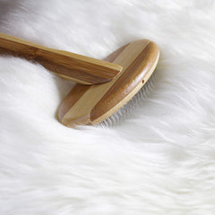 Outlavish wire carding brush detail highlighting the beveled bamboo handle.