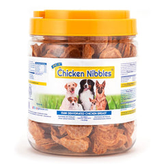 PCI Chicken Nibbles dog treats shown from the front of the container.