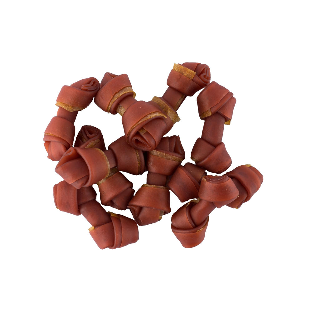 A dog chewing a SmartBones Mini Bones rawhide-free treat.
