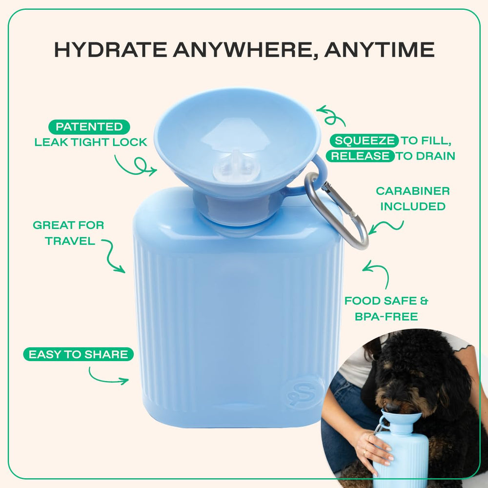 Springland Pets dog water bottle being gently squeezed to fill the bowl.