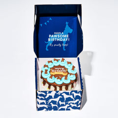 Thoughtfully Blue Dog Birthday Cookie Cake with a close view of its hand-decorated blue icing.