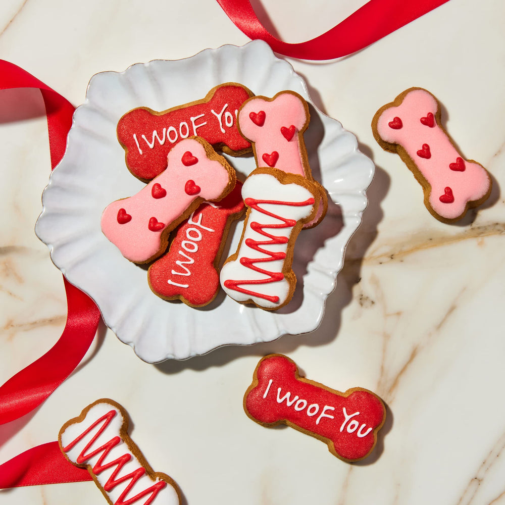 Thoughtfully Puppy Love dog treat biscuit showing its hand-decorated love theme.