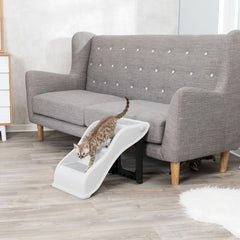 A pet using the TRIXIE pet stairs to climb to a resting spot.