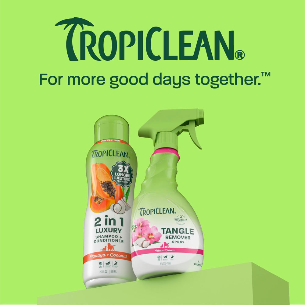 TropiClean dog detangler spray shown during coat brushing.