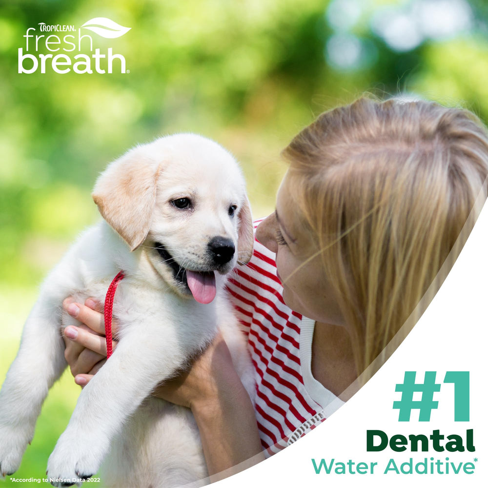 TropiClean Fresh Breath Dental Water Additive being poured for use.