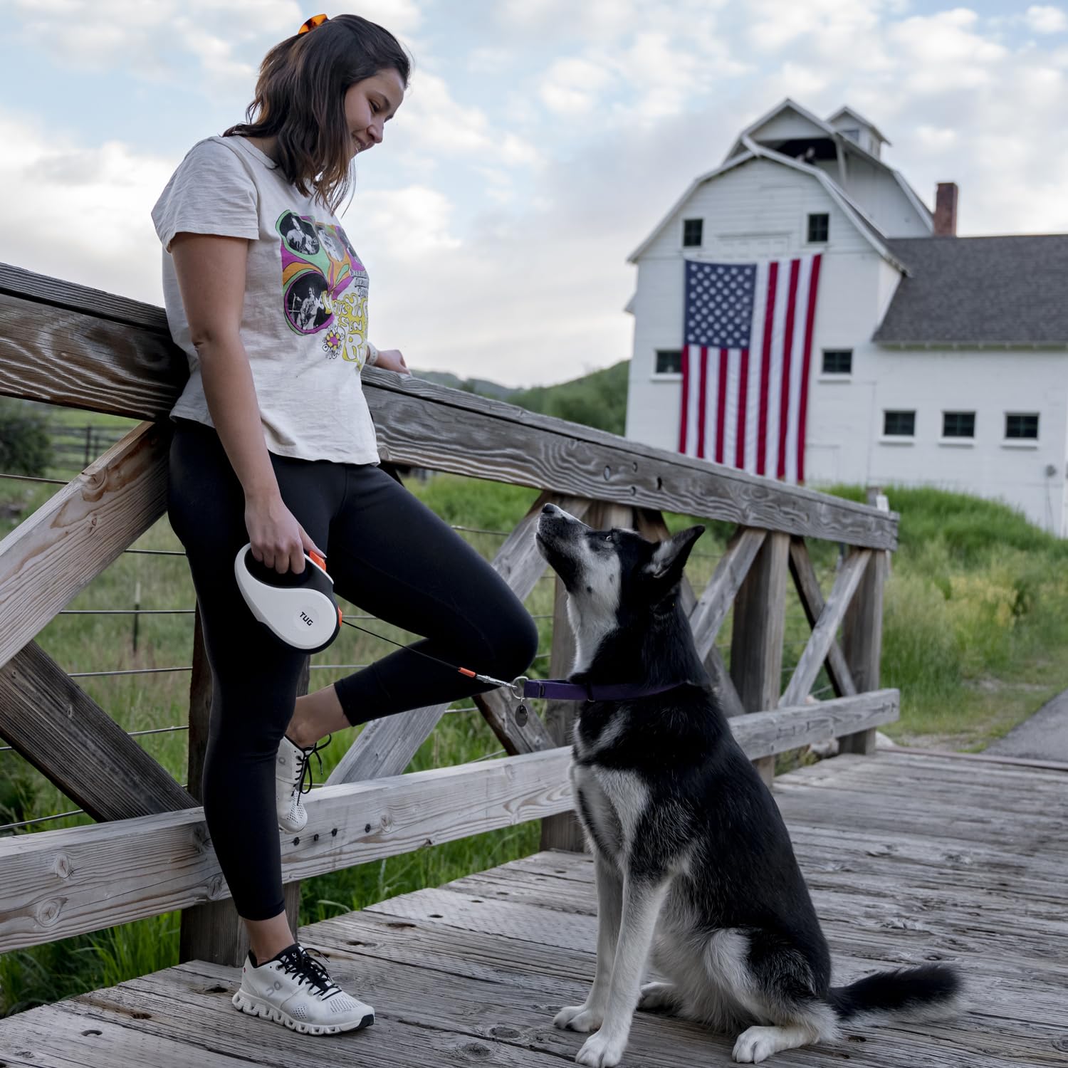TUG retractable dog leash with its tape extended for a walk.
