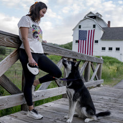 TUG retractable dog leash with its tape extended for a walk.